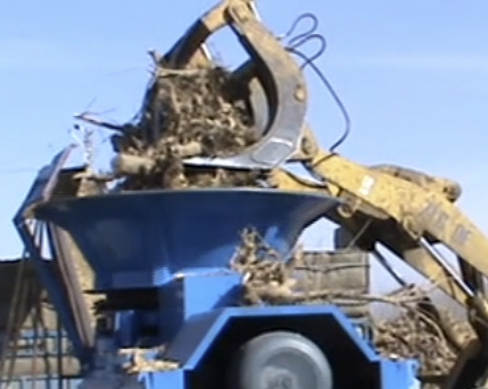 Loading stumps into chipping machine